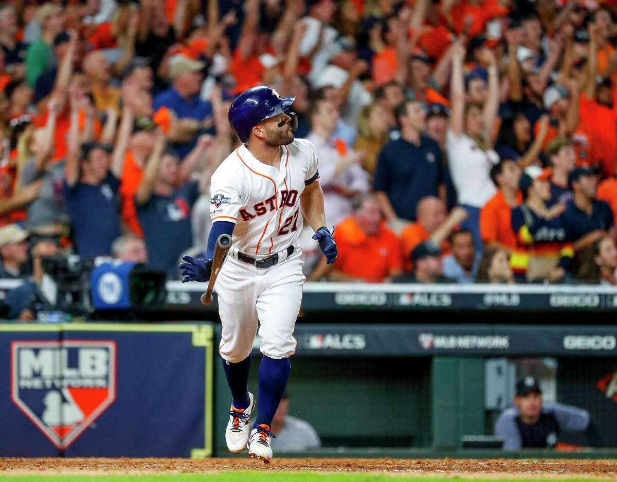 Houston Astros second baseman Jose Altuve (27) hits a two-run, walk-off, series-winning run in the bottom of the ninth inning of Game 6 of the American League Championship Series at Minute Maid Park in Houston on Saturday, Oct. 19, 2019.