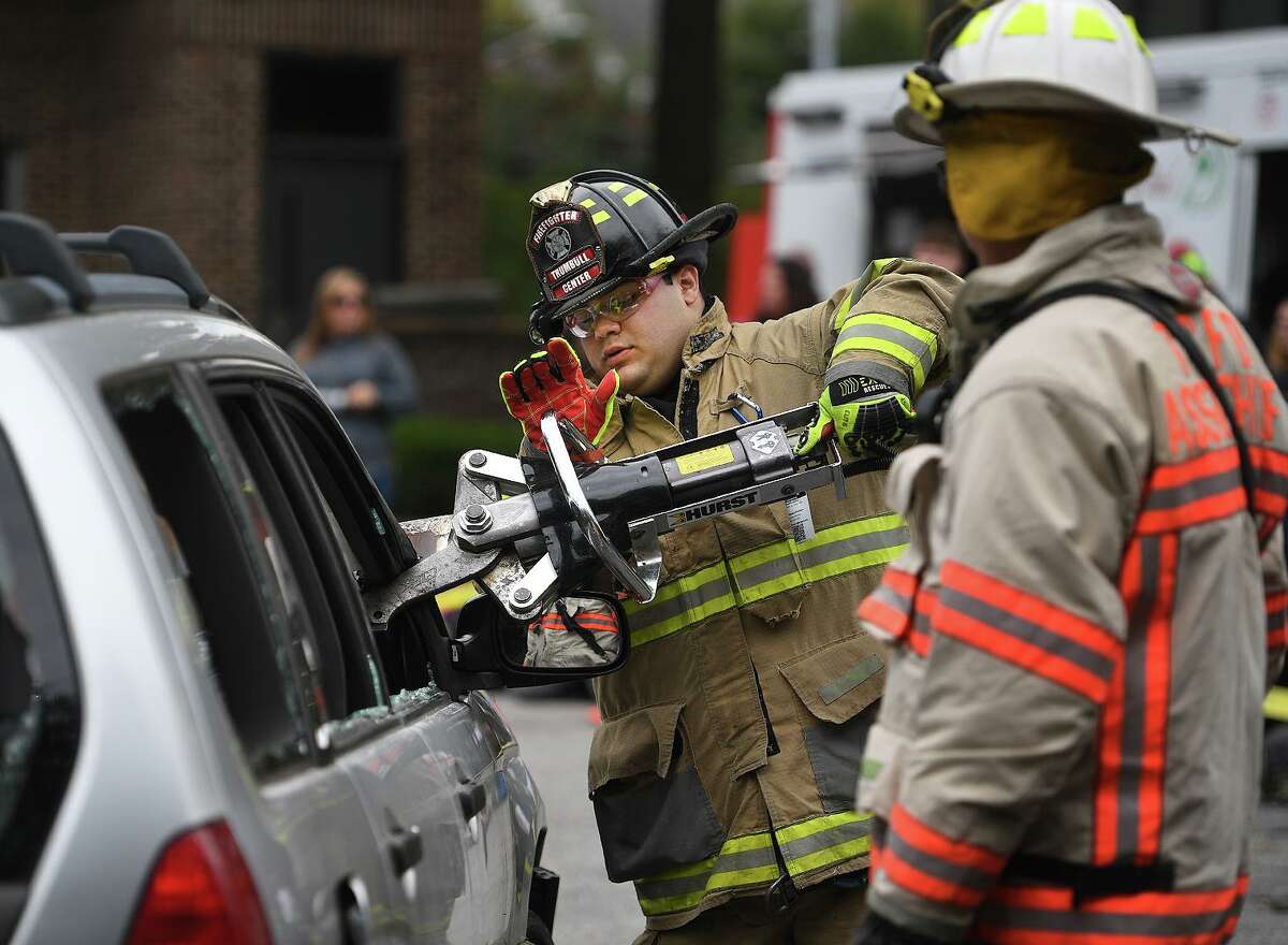 Trumbull firefighter Scott Lanahan cuts the roof from a car during a rescue demonstration at Trumbull Volunteer Fire Co. #1 at 860 White Plains Road in Trumbull, Conn. on Sunday, October 20, 2019. The demo was one of many events at a day long open house at the station.