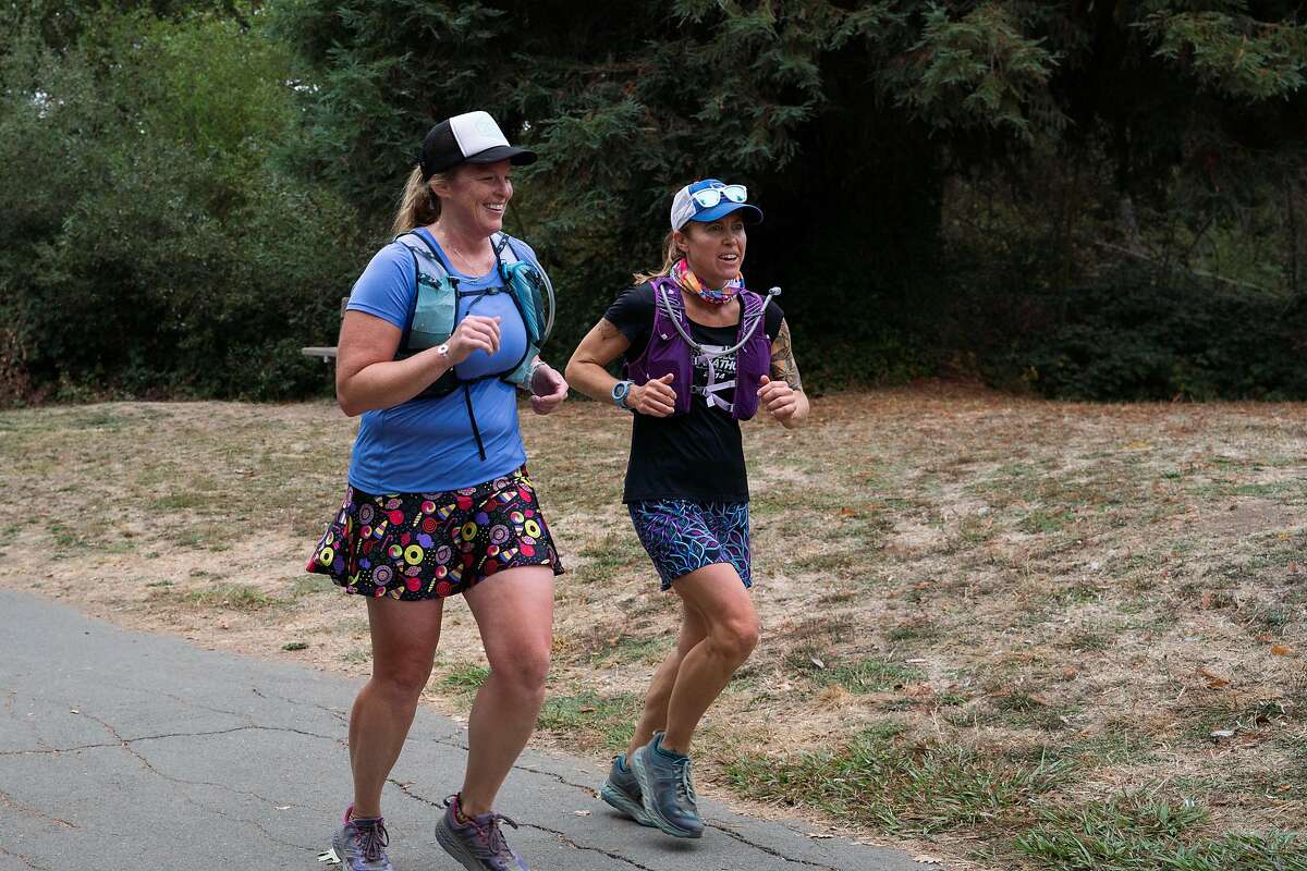 Brandelle McIntosh, left, and Marina Jennifer James jog during a trail run hosted by Healdsburg Running Company at Annadel State Park in Santa Rosa, Calif. on Saturday, Oct. 19, 2019.