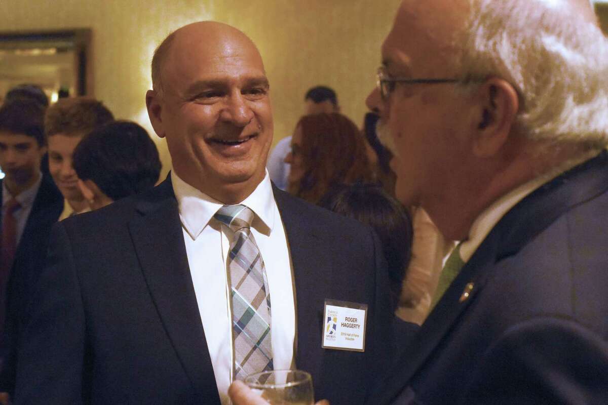 Stamford’s Roger Haggerty shares a laugh with Roger Fox during the Fairfield County Sports Commission’s annual Sports Night awards dinner at the Stamford Marriott on Monday. Haggerty was inducted into the FCSC Hall of Fame in the James O’Rourke Amateur Wing.