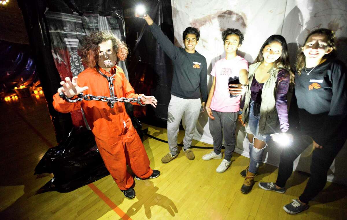From left Christian Tarzia and members of the Senior Class Student Council, Adarsh Sushanth, Lalith Goli, Geetha Weerakoon and Samantha Heller set up for the sixth annual Haunted Scare House at Stamford High School in Stamford, Connecticut., Friday, Oct. 19, 2018. The haunted house is back again this year, one of many Halloween-themed events to check out in Stamford this month.