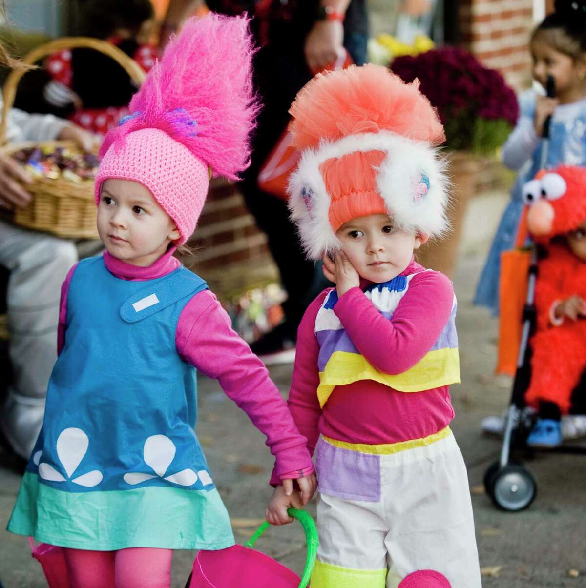 Twins Piper and Penelope Howatt, 3, search for candy on Main Street.