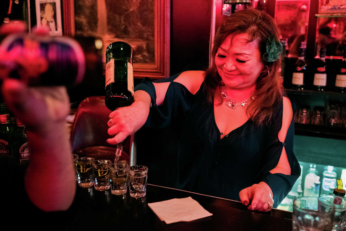 Hsiu-Mei Wong, aka "Mama Candy," pours shots at Chinatown's Bow Bow Cocktails in 2019.