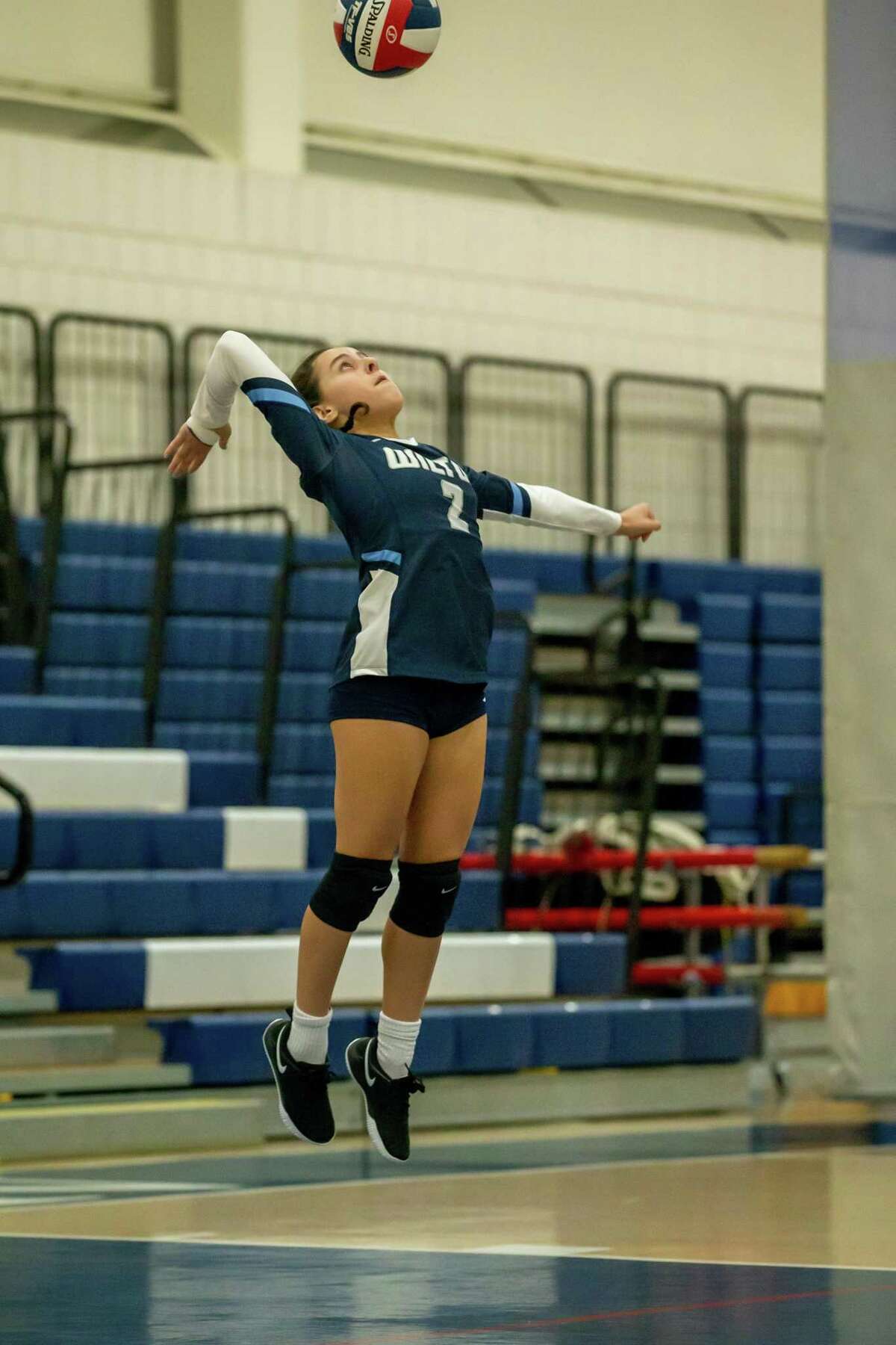 Gillian Lipsky hits a jump-serve during the Wilton girls volleyball team's 3-0 sweep of Bridgeport Central last week. It was the first win for the Warriors following 12 straight losses to start the season.