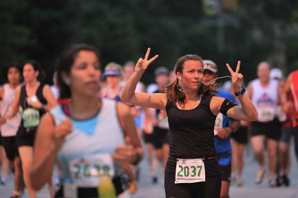 Dana Johnston greets her fans along the first mile of the Houston Half Marathon.