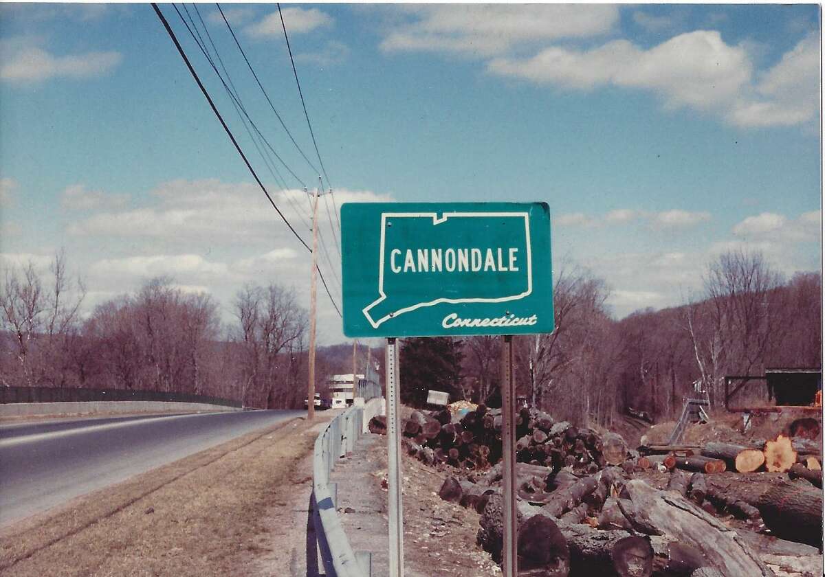 An old, undated photo shows a sign indicating the beginning of Cannondale at Gregory's Sawmill on Danbury Road.