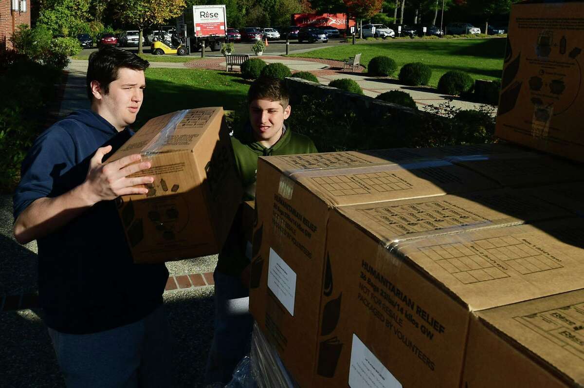 Hundreds of volunteers including Patrick Cummins and Anthony Gili help package meals for Wilton’s Wi-ACT Interfaith Committee the 6th annual Rise Against Hunger meal packaging event Saturday, October 19, 2019, at Wilton Presbyterian Church in Wilton, Conn. Four shifts of nearly 750 volunteers will load a shipping container destined for Somalia with the completed meals.