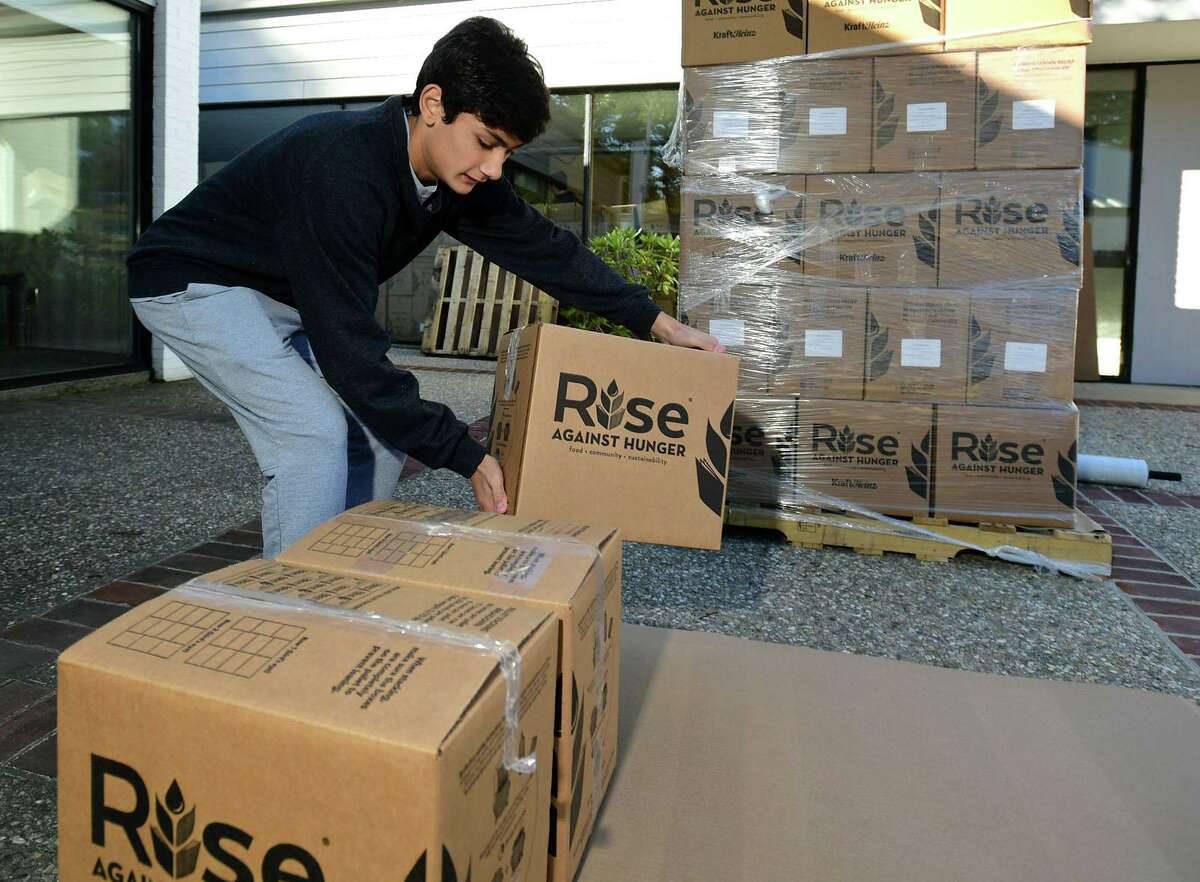 Hundreds of volunteers including Rocco Gilis package meals for Wilton’s Wi-ACT Interfaith Committee the 6th annual Rise Against Hunger meal packaging event Saturday, October 19, 2019, at Wilton Presbyterian Church in Wilton, Conn. Four shifts of nearly 750 volunteers will load a shipping container destined for Somalia with the completed meals.