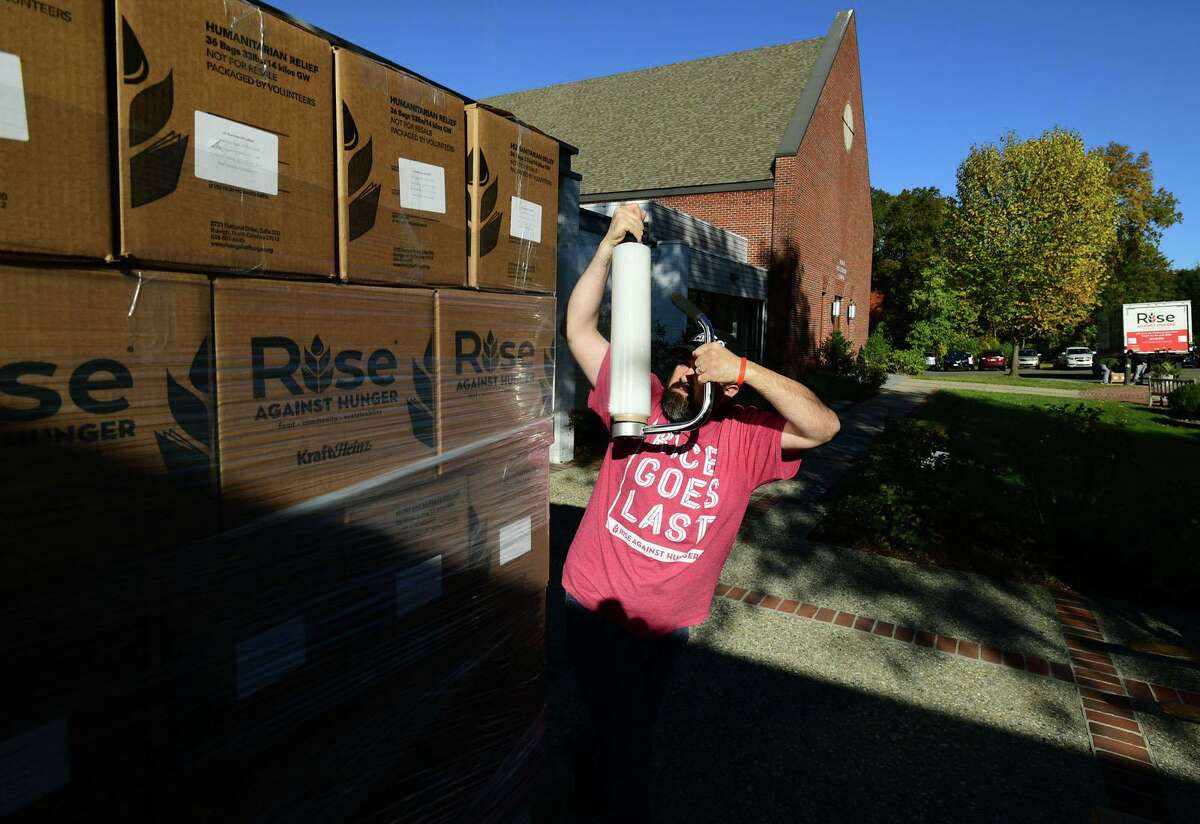 Rise Against Hunger Community Engagement Coordinator David Barletta helps hundreds of volunteers package and load meals for Wilton’s Wi-ACT Interfaith Committee the 6th annual Rise Against Hunger meal packaging event Saturday, October 19, 2019, at Wilton Presbyterian Church in Wilton, Conn. Four shifts of nearly 750 volunteers will load a shipping container destined for Somalia with the completed meals.