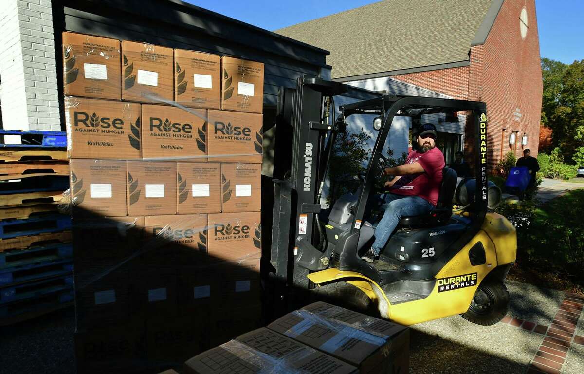 Rise Against Hunger Community Engagement Coordinator David Barletta helps hundreds of volunteers package and load meals for Wilton’s Wi-ACT Interfaith Committee the 6th annual Rise Against Hunger meal packaging event Saturday, October 19, 2019, at Wilton Presbyterian Church in Wilton, Conn. Four shifts of nearly 750 volunteers will load a shipping container destined for Somalia with the completed meals.