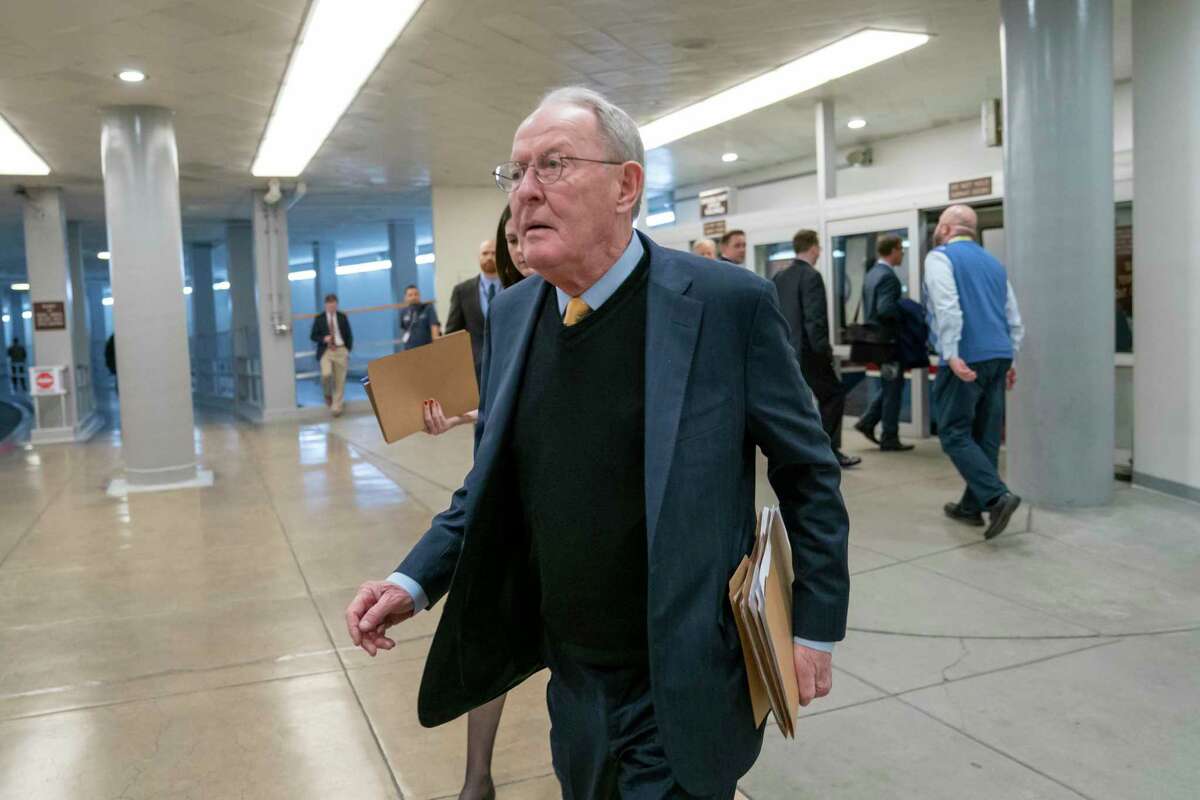 Sen. Lamar Alexander, R-Tenn., walks to the Senate at the Capitol in Washington, Feb. 12. A new study says about once in every six times someone is taken to an emergency room or checks in to a hospital as an in-patient, the treatment is followed by a “surprise” medical bill.