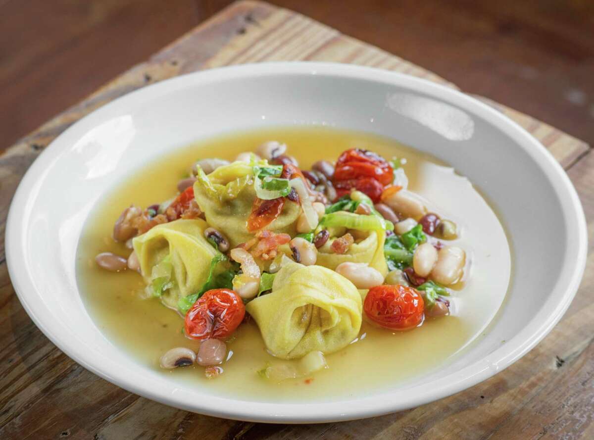 House tortellini, local beans, tomatoes, escarole, Parmesan broth, and saffron oil at Coltivare Wednesday, Aug. 21, 2019, in Houston.