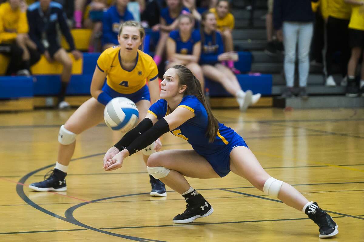 Midland's Edie Haase bumps the ball during a match against Dow Tuesday, Oct. 22, 2019 at Midland High School. (Katy Kildee/kkildee@mdn.net)