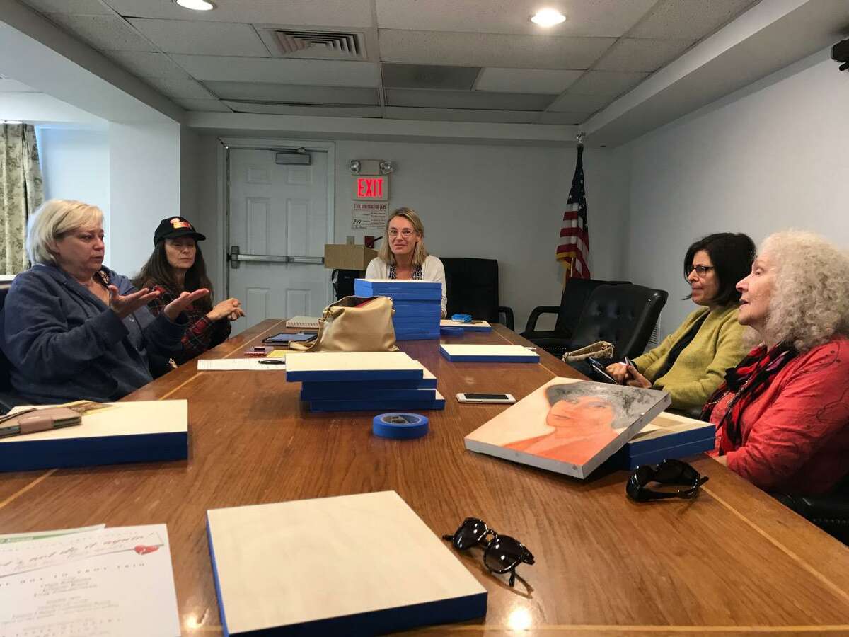 The “Portrait of Progress: From the Voting Booth to Town Hall” committee meets in the lower level conference room inside town hall.