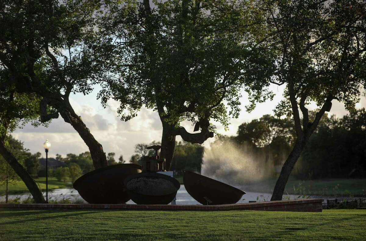 A sugar cane mill and three large bowls are photographed at a history park in Sienna Plantation on Thursday, Oct. 10, 2019, in Missouri City. According to a sign at the park, the mill, a "Kentucky #2" 725 pound mill, was produced between 1888-1905, and it was powered by two mules turning in a circle. This type of mill would have been used to crush sugar cane grown in the region in the mid 1800s.