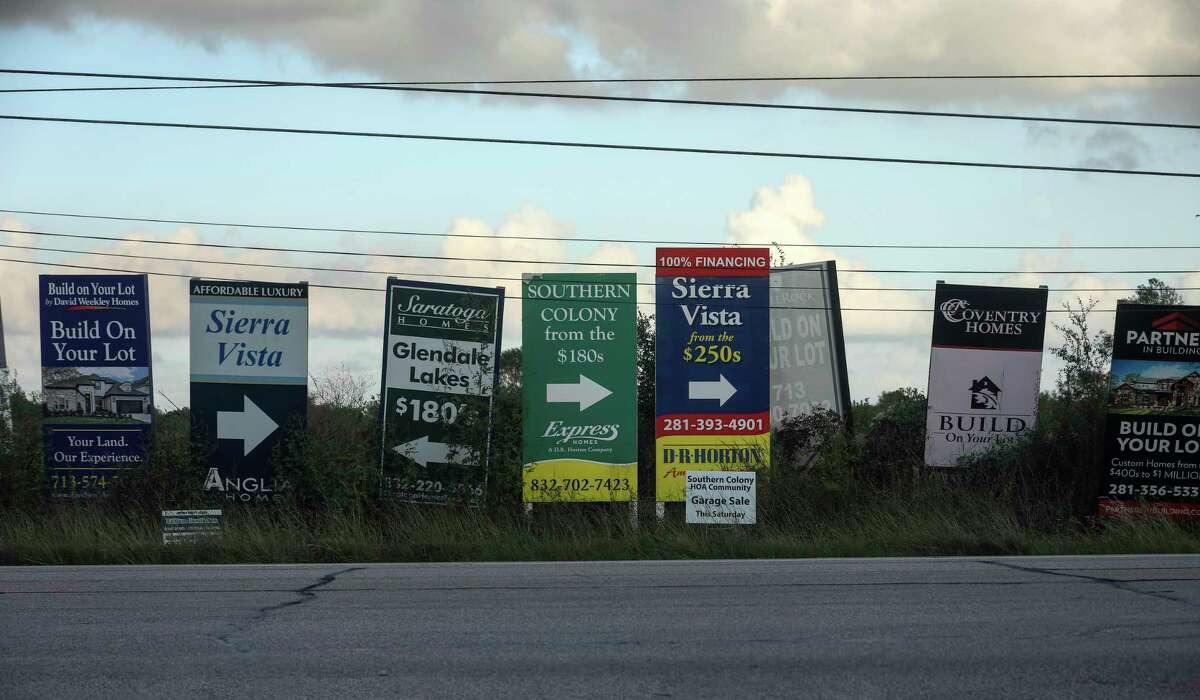 Signs advertising homes in the Sienna Plantation community, photographed on Thursday, Oct. 10, 2019, in Missouri City.