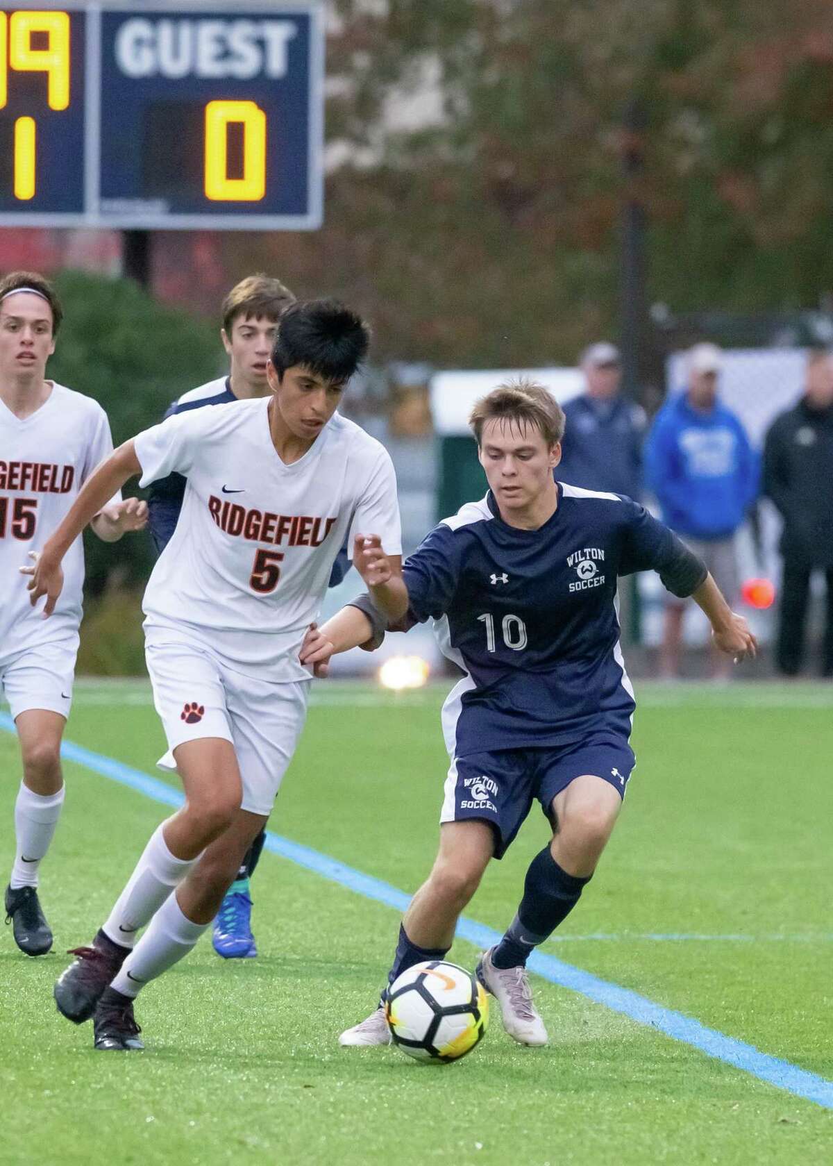 Wilton's Connor Uitterdijk (right) vies for the ball with Ridgefield's Ludwin Godoy during Tuesday's 1-1 tie.