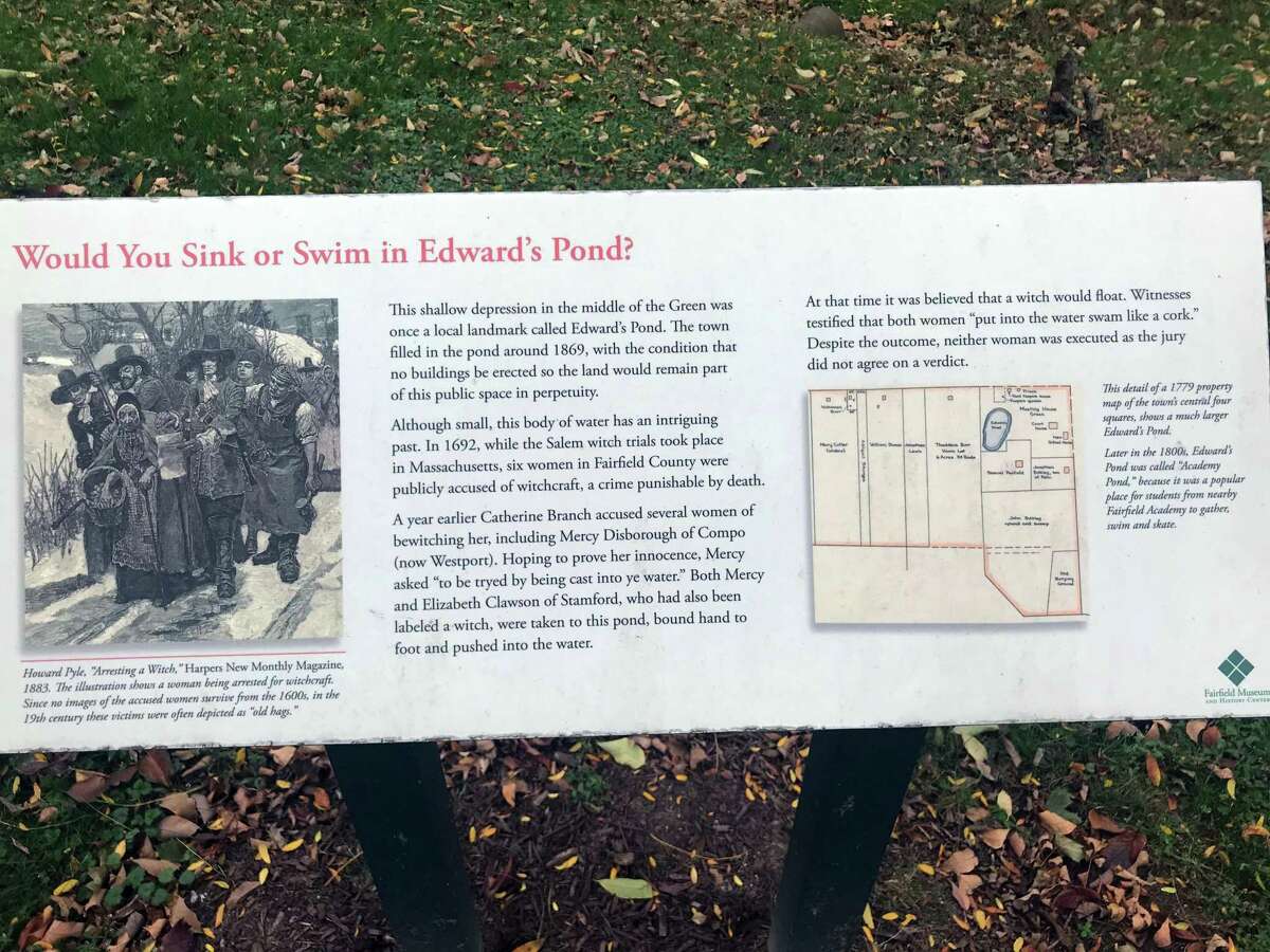 A sign behind Fairfield's Town Hall commemorates the area where accussed witches were once "dunked." Taken Oct. 16, 2019 in Fairfield, Conn.