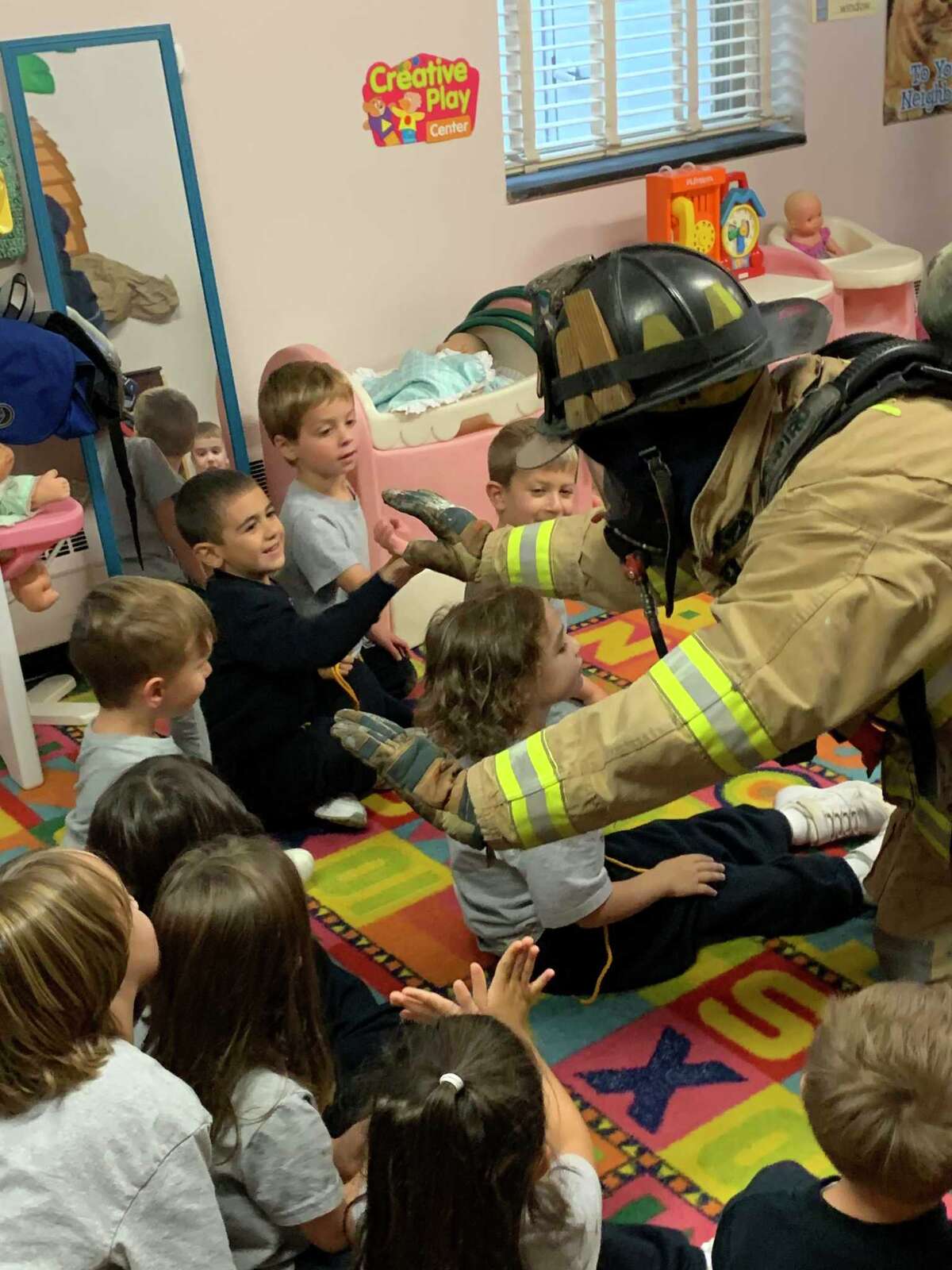 For Fire Safety Month, Milford firefighters visited St. Mary School to talk to preschool and kindergarten students about gear and all the parts of the big trucks.
