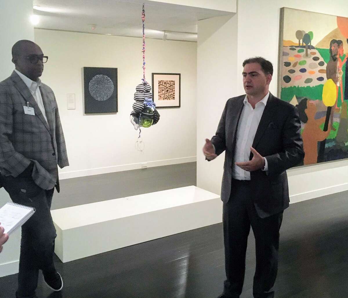 Atheneum Director Thomas Loughman, right, talks about the new exhibit at a preview as curator and artist Berrisford Boothe of the Petrucci Family Foundation looks on.