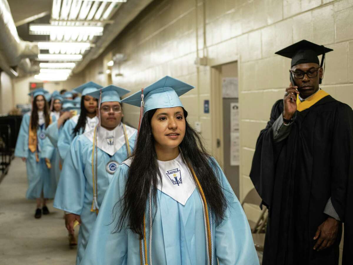 Valedictorian Izabella Monreal leads her classmates to the stage during the graduation of St. Philip's Early College High School last June. The Alamo Colleges will study potential new partnerships in an expansion of early college high schools in several school districts.