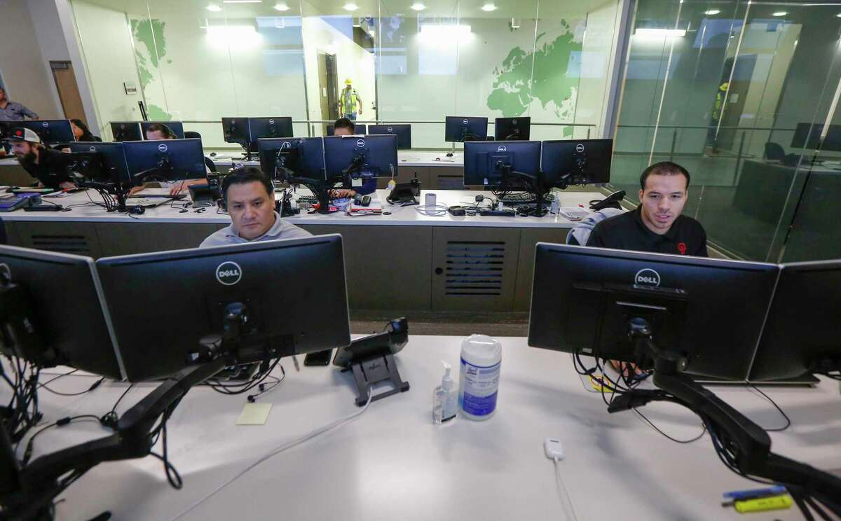 Julio Prado (left) and Marquis Newberry-Payne work in a computer operations room in Data Foundry - Houston 2 Wednesday, Oct. 23, 2019, in Houston.