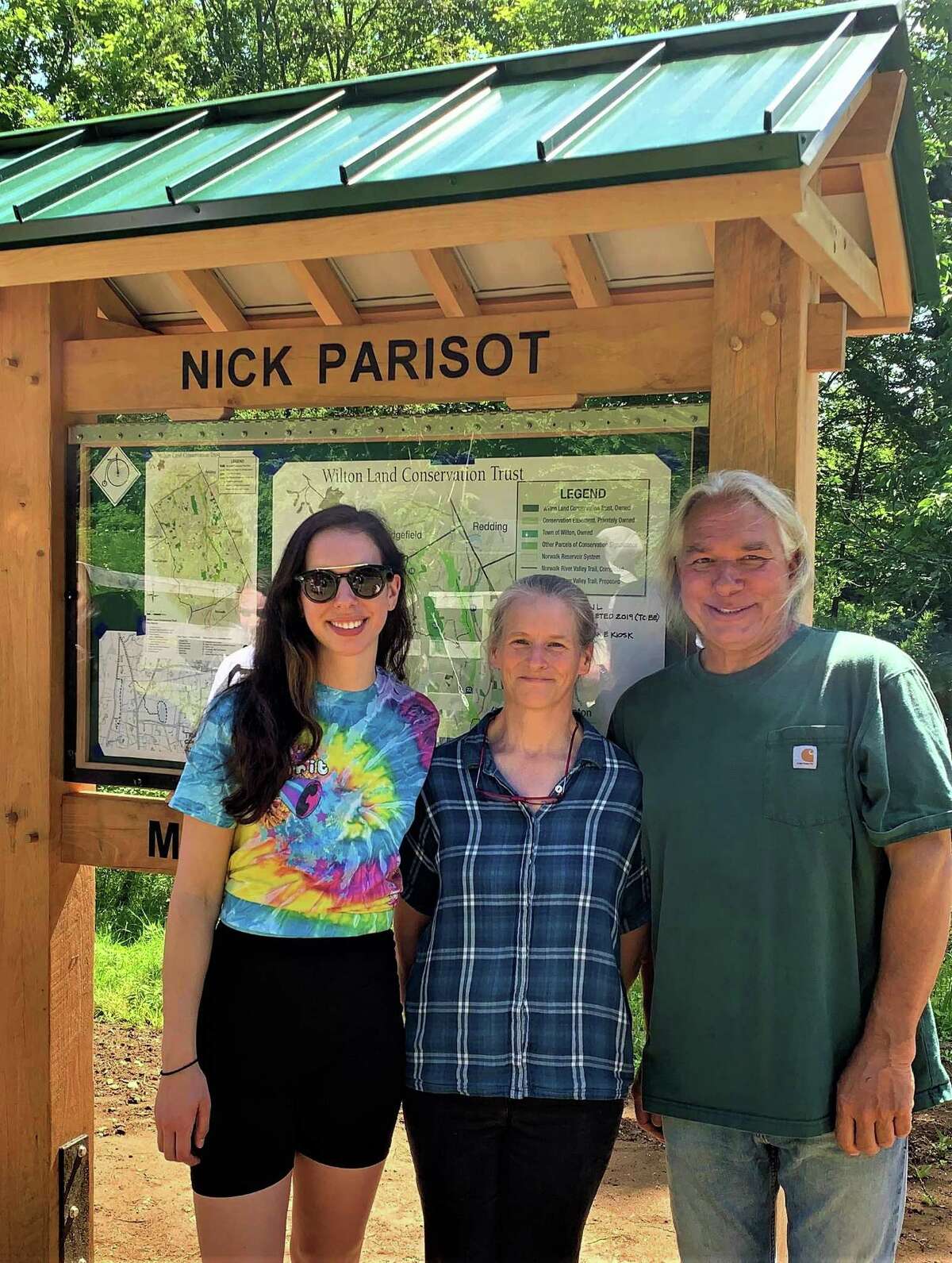 Nick Parisot's sister Michelle Parisot, his mother Kate Throckmorton, and his father Rick Parisot at the dedication this summer of a kiosk at the head of a trail blazed in Nick's memory.