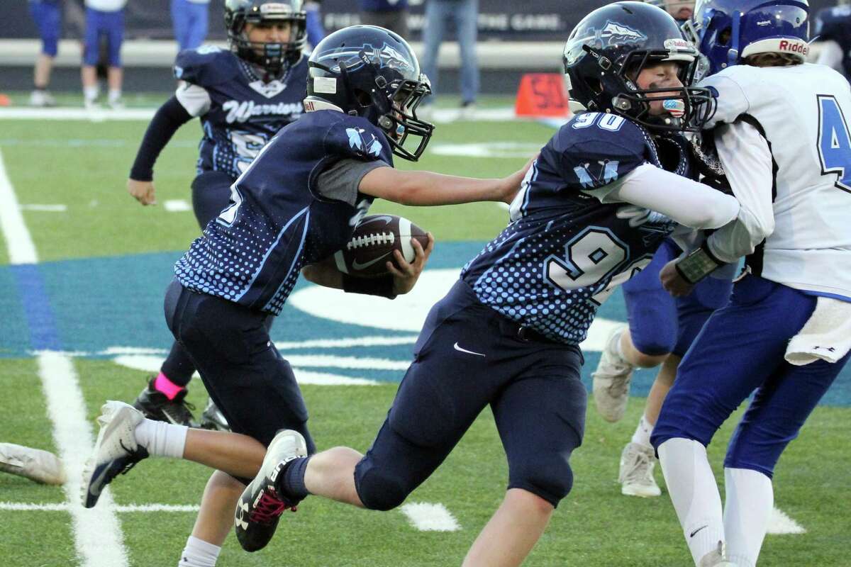 Curtis Jackson throws a blocks for Craig O'Neill, who scored a touchdown on the play for the Wilton 6th grade team in its win over Darien.