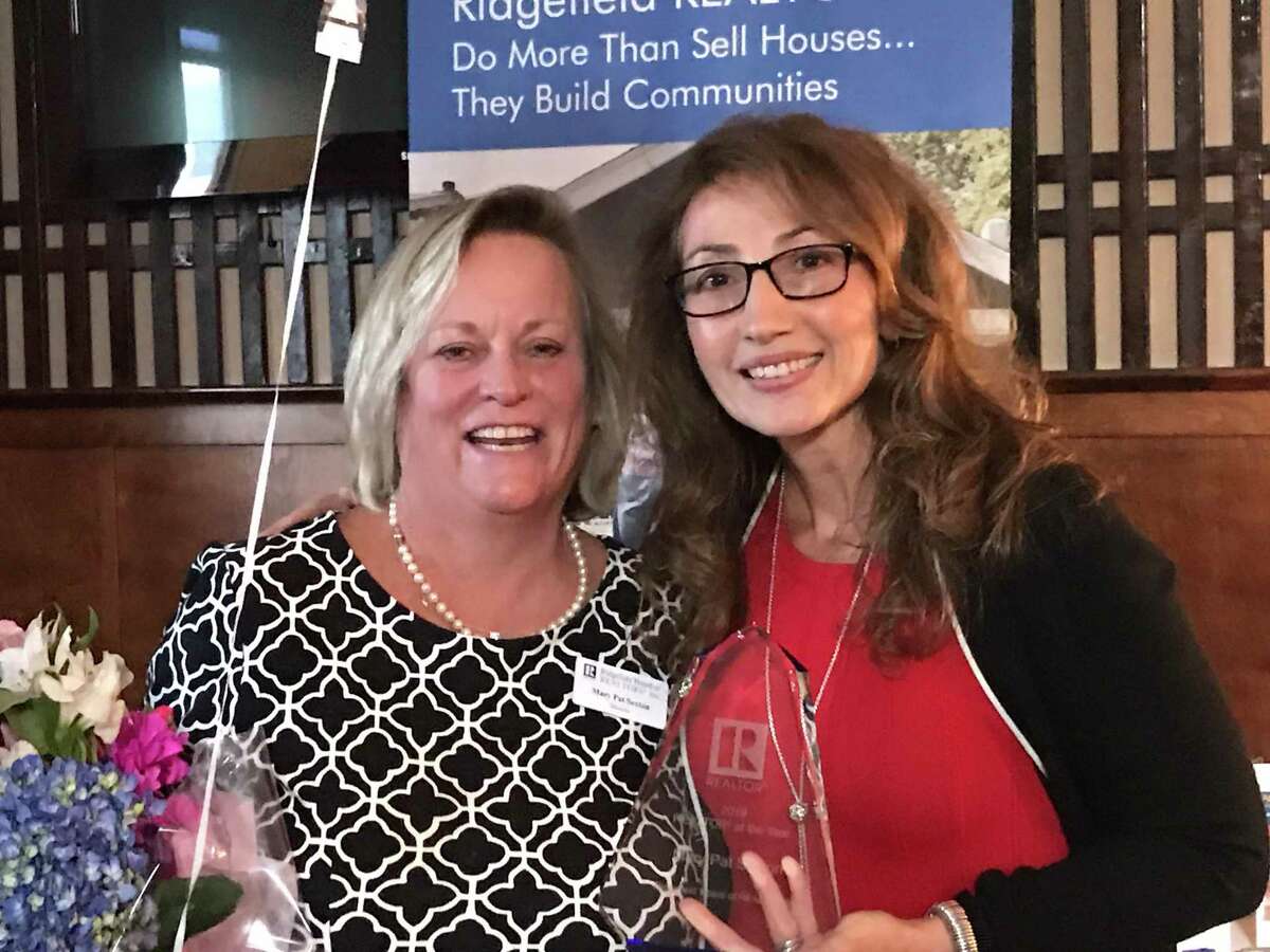 Mary Pat Sexton, left, receives the 2019 Realtor of the Year Award from Ridgefield Board of Realtors (RBOR) President Toni Riordan at the board’s annual meeting and trade expo on Oct. 23.