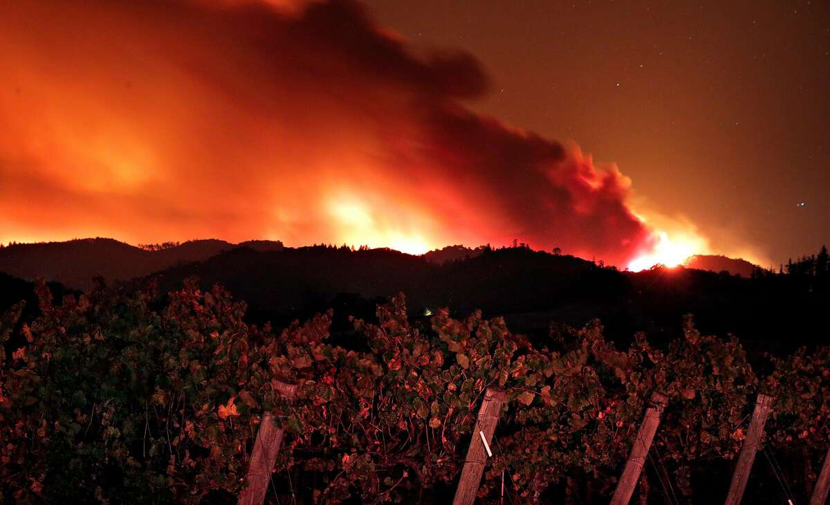 The fire crests the ridge east of Red Winery Road as the Kincade Fire burns outside Geyserville, Calif., on Thursday, October 24, 2019.