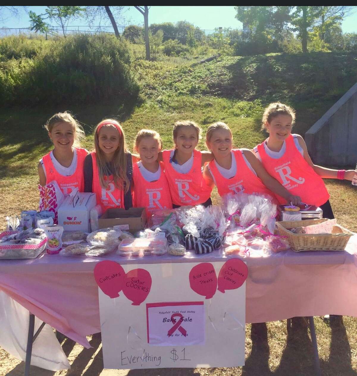 Ridgefield youth field hockey players at their bake sale table in front of Tiger Hollow on Oct. 19.