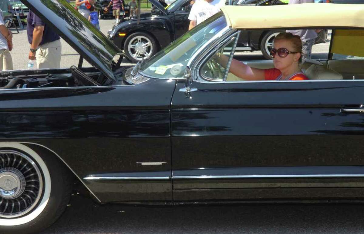 Elaine Scanlon, of Greenwich, with her 1951 Cadillac convertable at St. Roch's first car show on Sunday, Aug. 8, 2010.
