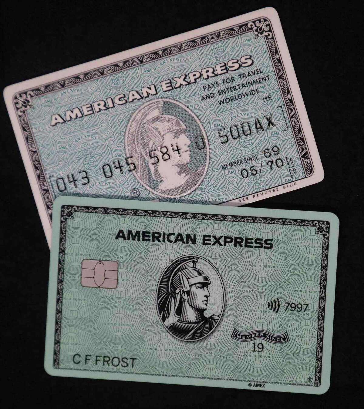 In this Wednesday, Oct. 23, 2019, photo the original American Express "Green Card," top, shown with the latest version of the card in New York. For 50 years the "Green Card" was everywhere and has been revamped, with a new look and more travel benefits. (AP Photo/Bebeto Matthews)