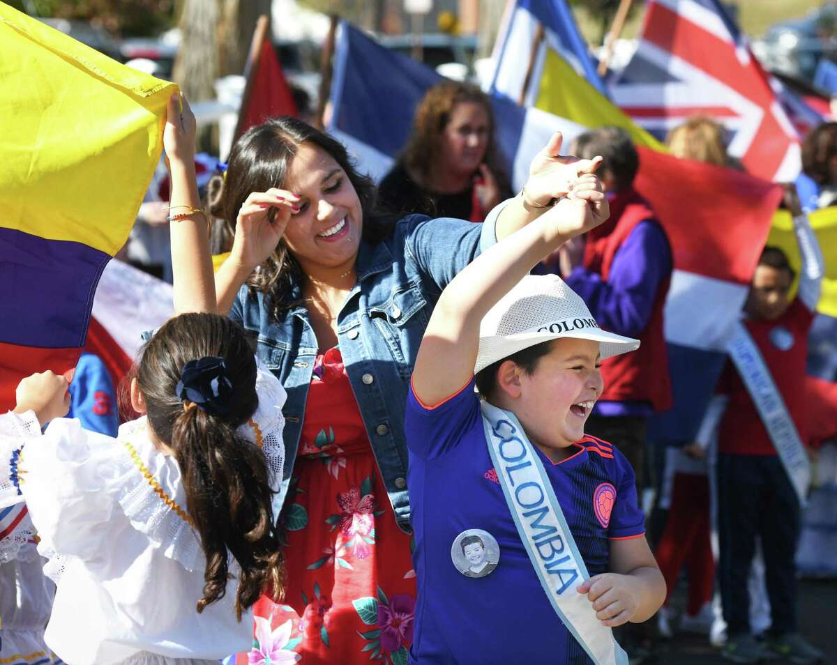 Third-grade teacher Jenna Mazzilli dances with fourth-grader Ryan Miranda, representing Colombia, at the 29th Annual United Nations Day Celebration "Parade of Nations" at Julian Curtiss School in Greenwich, Conn. Thursday, Oct. 24, 2019. Students representing 67 countries and speaking 30 different languages marched in the parade, waving flags and wearing clothing to represent their family's heritage. UNICEF Special Advisor Nicolas Charles Pron spoke of the importance of the United Nations while two Julian Curtiss students shared their individual stories of immigration. Additionally, a special photography project showcasing the diversity of the student population was on display.
