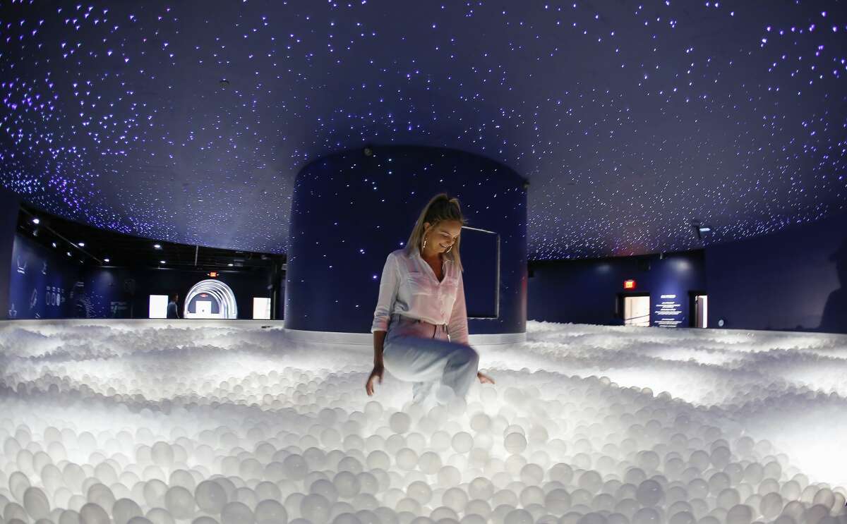 Kristin Zaccaria walks in the Black Hole Ball Pit at the Color Factory Houston Thursday, Oct. 24, 2019, in Houston.