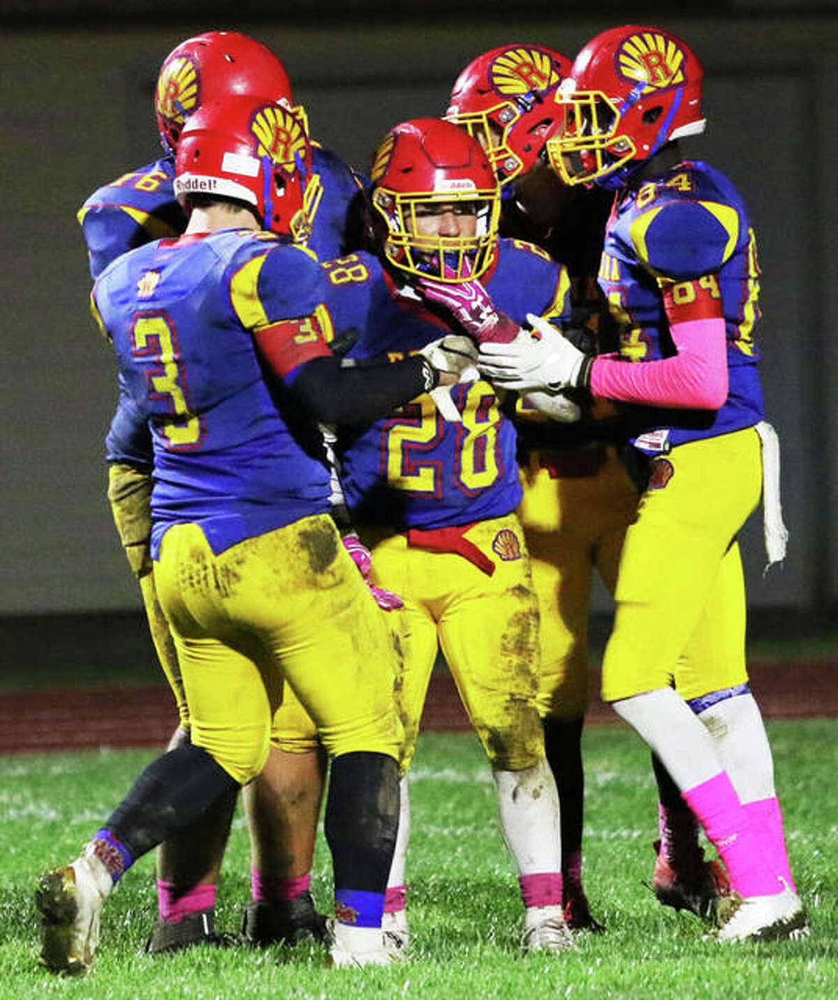 Roxana’s Michael Ilch (28) is congratulated by teammates after scoring a touchdown in the fourth quarter of a win over Gillespie on Oct. 11 at Raich Field in Roxana. The 4-4 Shells are in Piasa on Friday to play Southwestern in a game that would send Roxana to the playoffs with a victory.