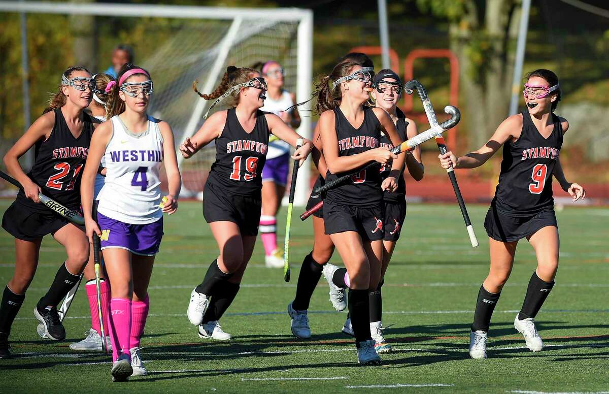 Stamford's Devon Yaghmaie (3) slaps sticks with her sister Taylor Yaghmaie (9) following her goal in the first half of a girls field hockey match against Westhill at J. Walter Kennedy Stadium in Stamford on Oct. 24, 2019.