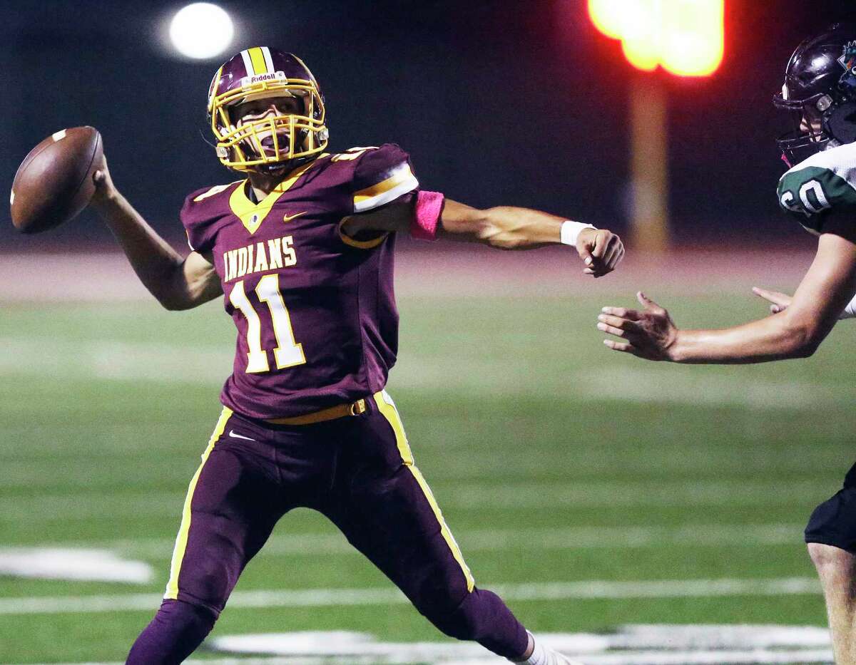 Indians quarterback Joseph Rodriguez gets off a pass under pressure from Zach West as Harlandale hosts Southwest at Harlandale Stadium on 24, 2019.