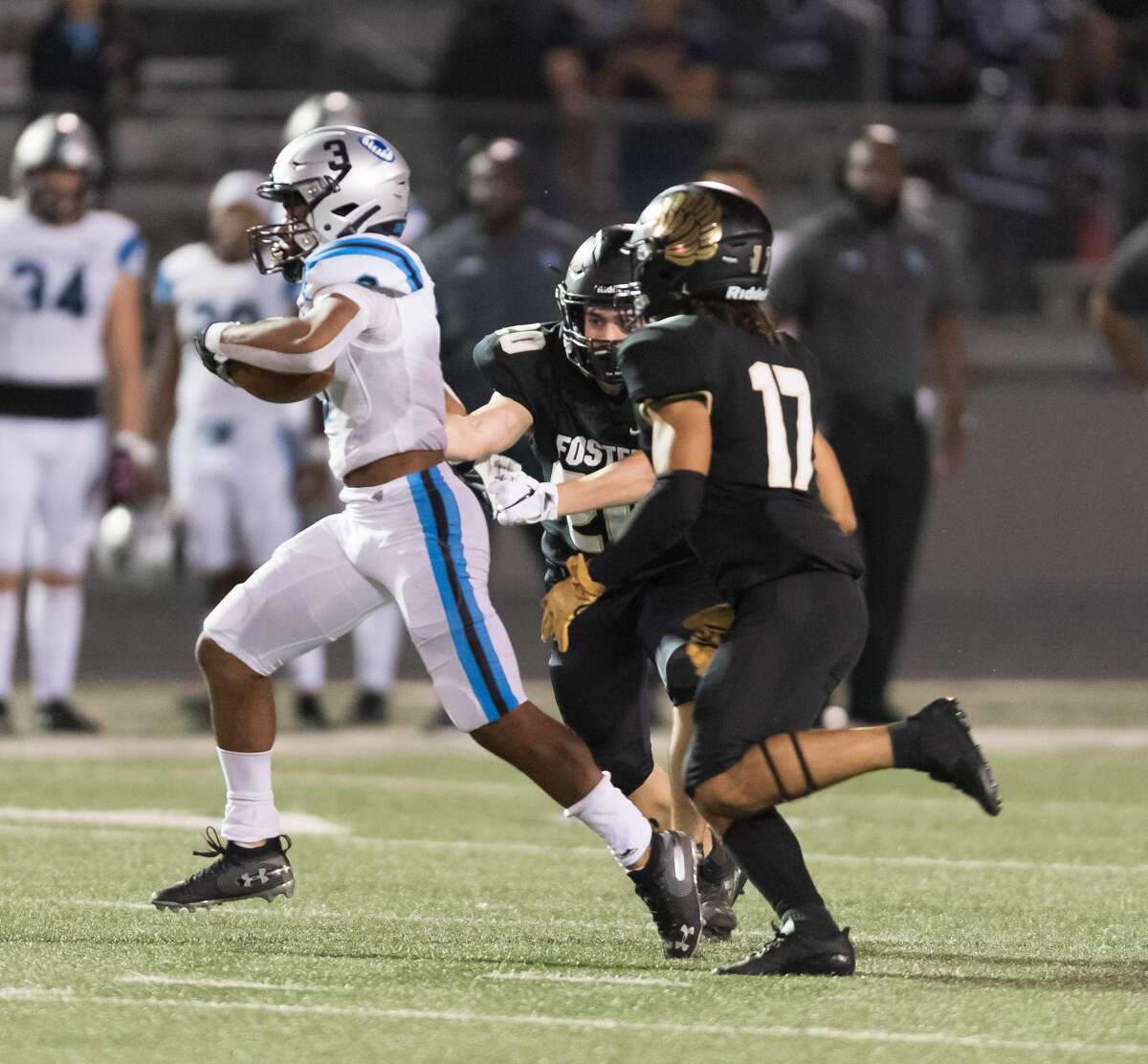 Kelvon Brown (3) of the Shadow Creek Sharks breaks from the grip of Ethan Kappes (20) of the Foster Falcons for a long run in the second half in a high school football game on Thursday, October 24, 2019 at Traylor Stadium in Rosenberg Texas.
