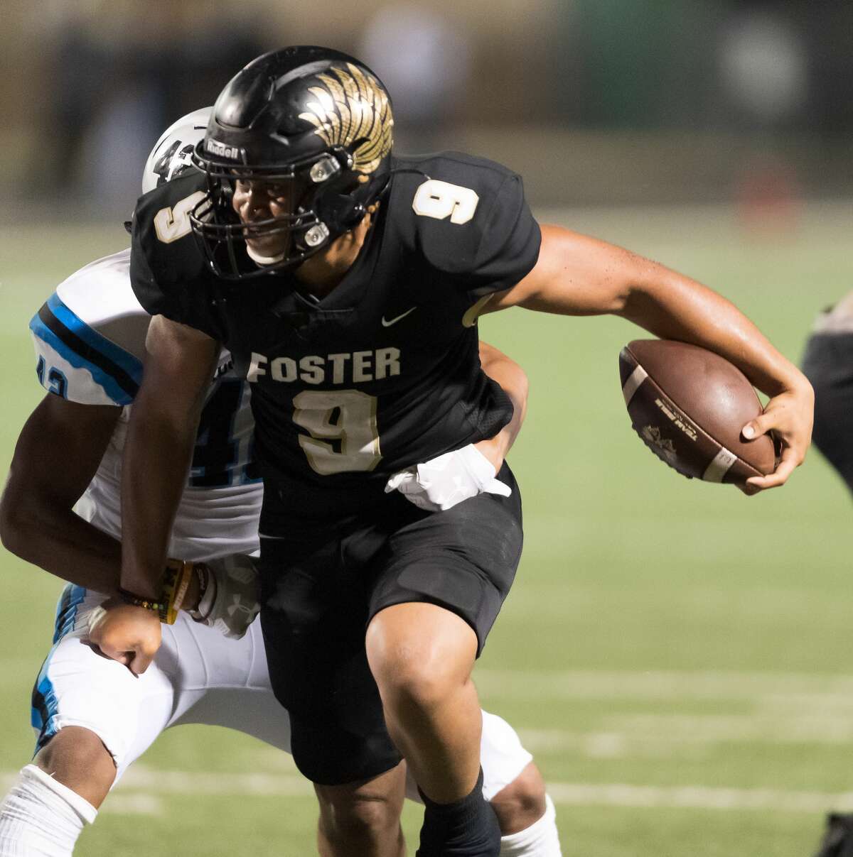 Issac Johnson (9) of the Foster Falcons runs for a short gain in the second half against the Shadow Creek Sharks in a high school football game on Thursday, October 24, 2019 at Traylor Stadium in Rosenberg Texas.