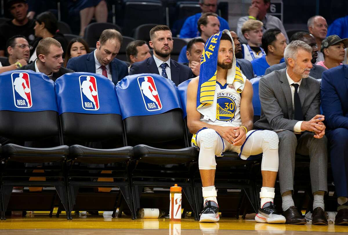 Golden State Warriors guard Stephen Curry (30) watches the subs finish out the team's season-opening NBA basketball game against the Los Angeles Clippers, at the new Chase Center on Thursday, Oct. 24, 2019 in San Francisco, Calif. The Clippers defeated the Warriors 141-122.
