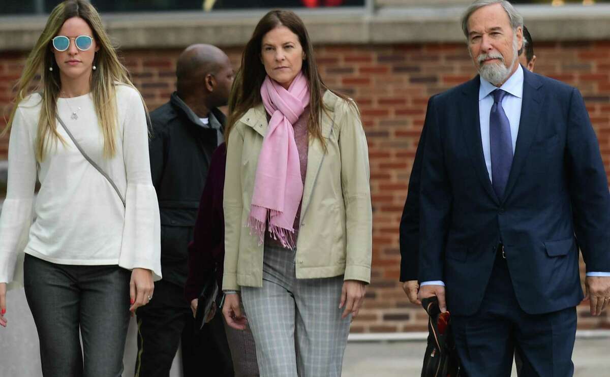 Michelle Troconis, center, arrives at the Stamford courthouse Friday morning for a pre-trial hearing on tampering with evidence and hindering prosecution charges in Jennifer Dulos’ disappearance.