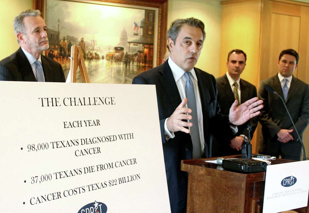 In this Jan. 20, 2009 file photo, James Mansour, center, then board chairman of the Cancer Prevention and Research Institute of Texas, announces the release of $60 million in grants for cancer research projects in Texas during a news conference in Austin, Texas. Ten years later, voters are being asked to approve a $3 billion bond initiative to keep CPRIT going another 10 years.