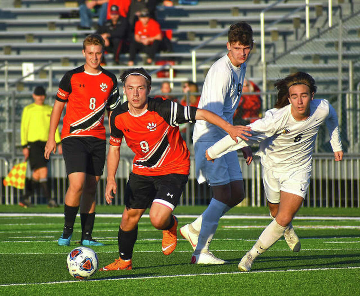 Edwardsville forward Cooper Nolan comes out of a pile-up with possession during a game against Granite City in Edwardsville.