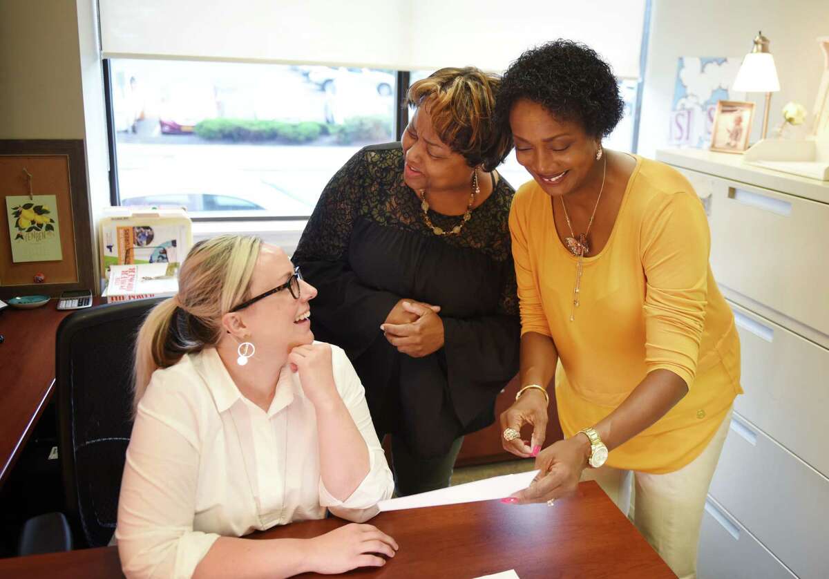 Crickett Thomas-O'Dell, regional director at Workforce Development Institute, right, works with Ana Culver, grant program manager, left, and office manager, Wanda Parsons, center, at the WDI offices on Thursday, Sept. 12, 2019, in Troy, N.Y. (Will Waldron/Times Union)