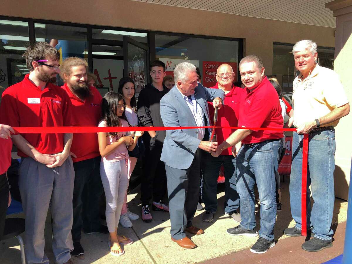 At the ribbon cutting of Mathnasium are, from left, Alec, Zac, and Tom of Mathnasium, Mayor Harry Rilling of Norwalk, Mathnasium owner Dmitry Krieger and Brian Perry, board member of the Wilton Chamber.