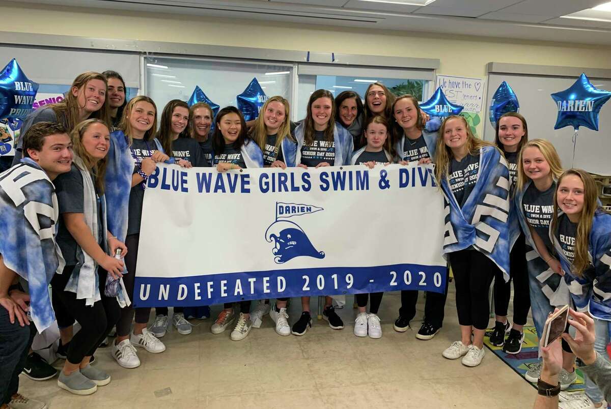 The Darien swimming and diving team celebrates its senior night victory against Warde on Oct. 23, 2019.