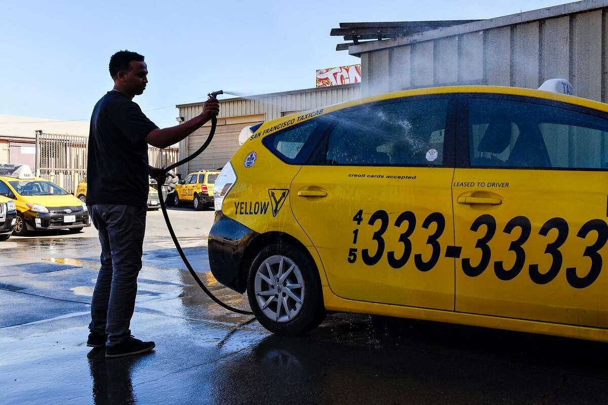 Ayenom Gebremedhin washing a taxi cab in the mechanic shop at Yellow Cab headquarters in San Francisco on October 23, 2019 in San Francisco, Calif.