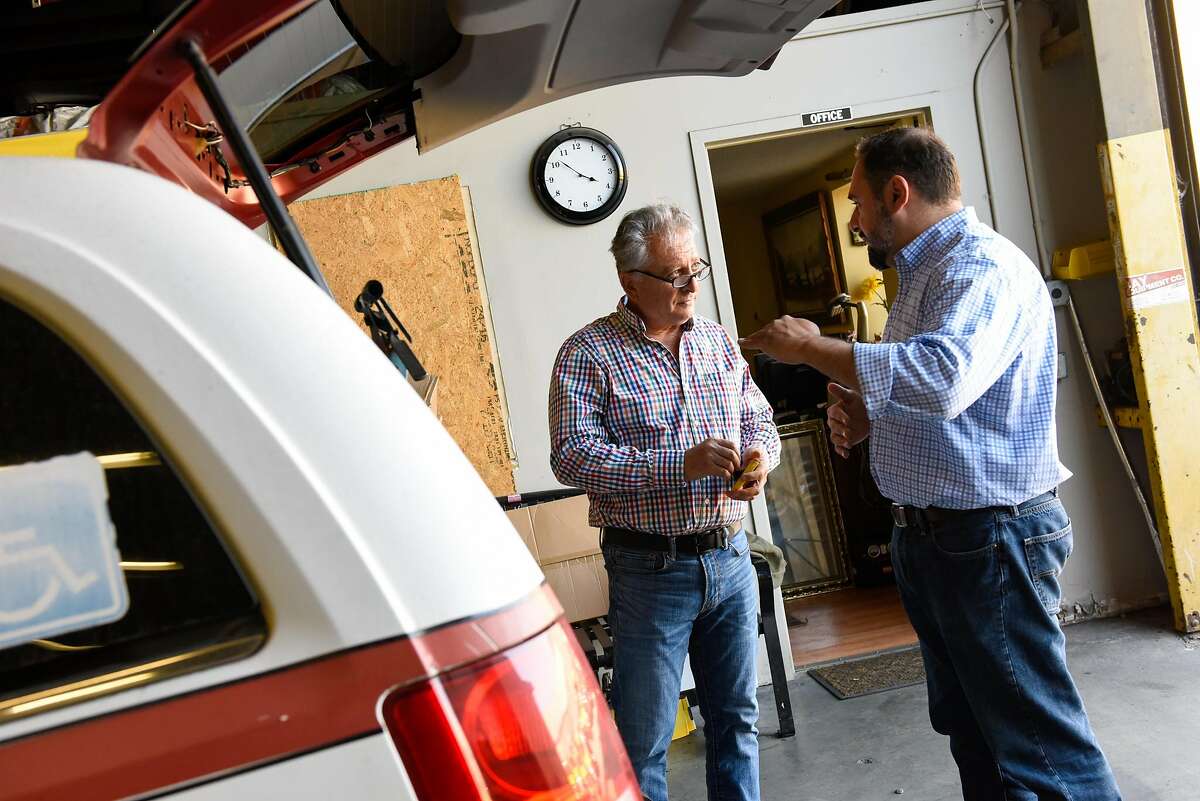 Jam Khajvanei, mechanic shop manager, discusses changes needed for a handicap taxi cab with Chris Sweis, CEO, at Yellow Cab headquarters in San Francisco on October 23, 2019 in San Francisco, Calif.