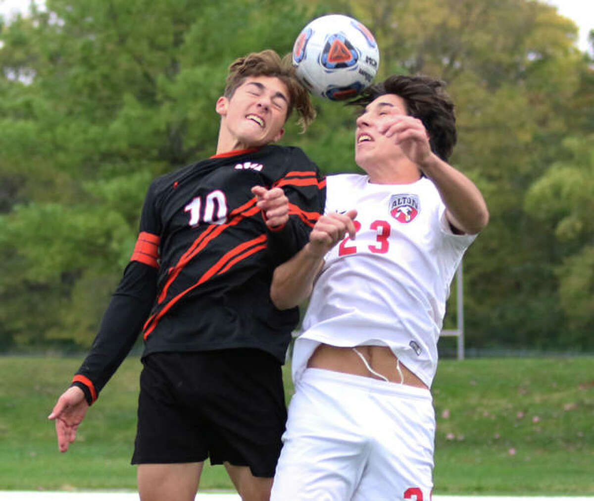 Alton’s Justin Davison (right) and Edwardsville’s Jakob Doyle vie for a headball near the Redbirds goal early in the Class 3A regional title match Friday in Edwardsville.